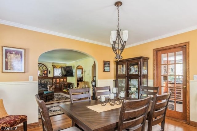 947 Madison Ave, Plainfield City, NJ 07060 - dining area with a chandelier, arched walkways, crown molding, and wood finished floors