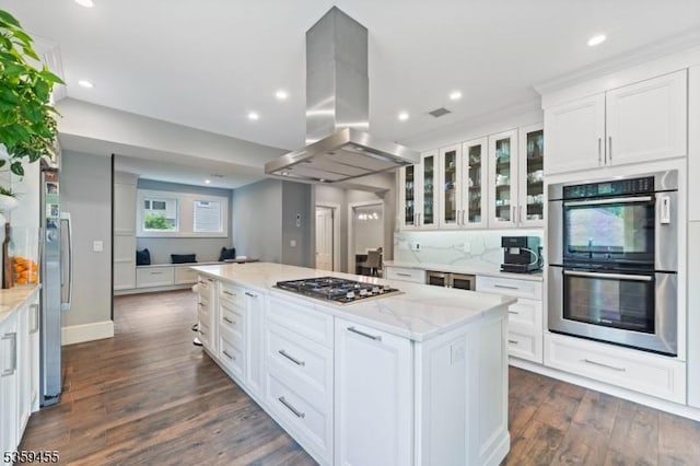 296 Highfield Ln, Nutley Twp, NJ 07110 - kitchen with stainless steel appliances, island exhaust hood, white cabinetry, dark wood finished floors, and a center island
