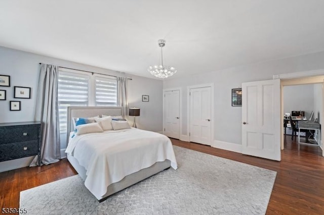 296 Highfield Ln, Nutley Twp, NJ 07110 - bedroom with a chandelier, dark wood-style floors, and two closets