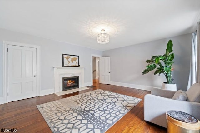 296 Highfield Ln, Nutley Twp, NJ 07110 - living area featuring baseboards, wood finished floors, and a fireplace