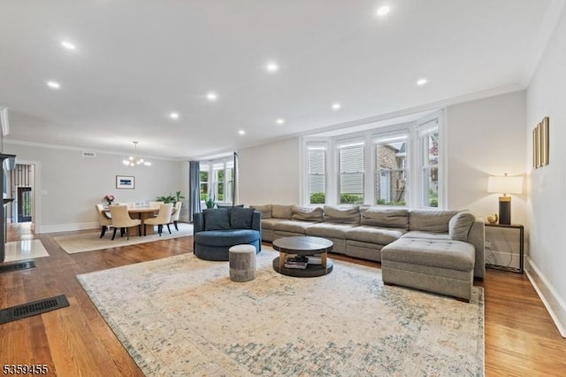 296 Highfield Ln, Nutley Twp, NJ 07110 - living area with ornamental molding, wood finished floors, baseboards, recessed lighting, and a chandelier