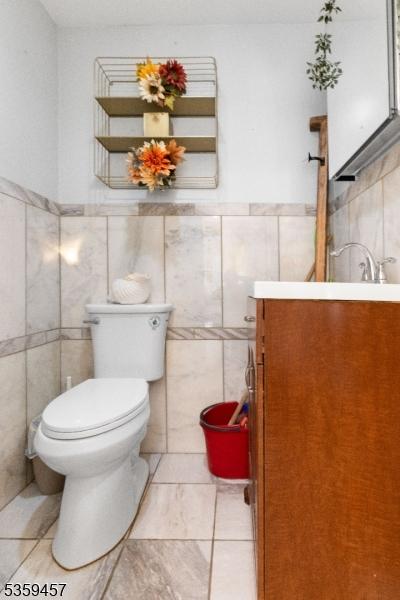 31 Mertz Ave, Belleville Twp, NJ 07109 - bathroom with vanity, tile walls, and wainscoting