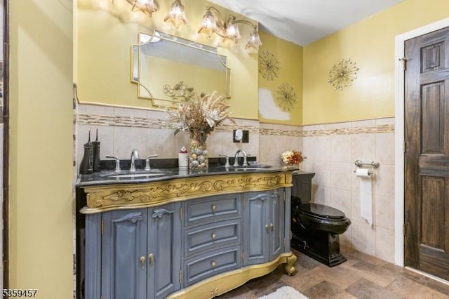 31 Mertz Ave, Belleville Twp, NJ 07109 - bathroom with tile walls, double vanity, and a wainscoted wall