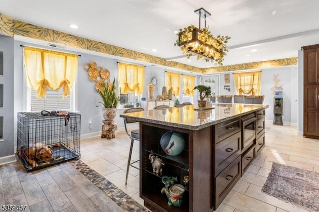31 Mertz Ave, Belleville Twp, NJ 07109 - kitchen featuring a kitchen bar, open shelves, stainless steel microwave, light stone counters, and decorative light fixtures