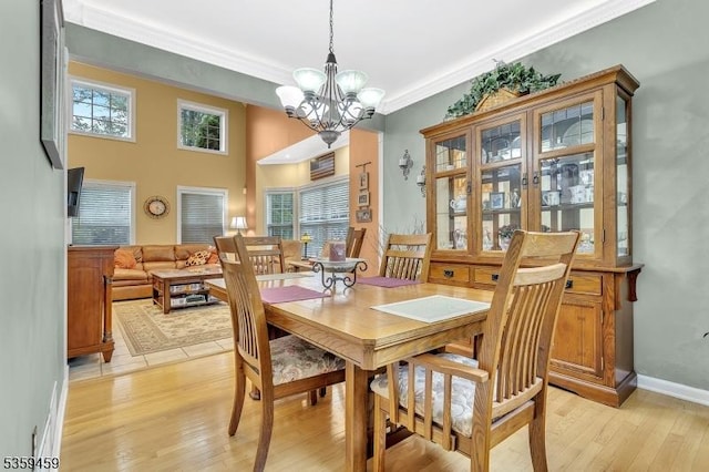 5 Ten Broek Ct, Bridgewater Twp, NJ 08807 - dining room featuring crown molding, healthy amount of natural light, a chandelier, light wood-style floors, and baseboards