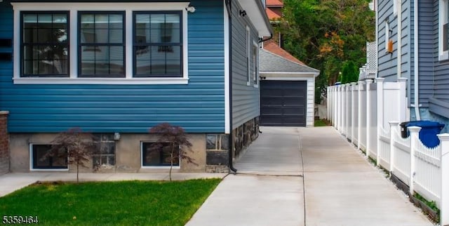 228 78th St, North Bergen Twp, NJ 07047 - view of home's exterior featuring concrete driveway and a detached garage