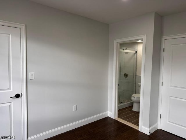 228 78th St, North Bergen Twp, NJ 07047 - unfurnished bedroom featuring dark wood-type flooring, baseboards, and ensuite bath