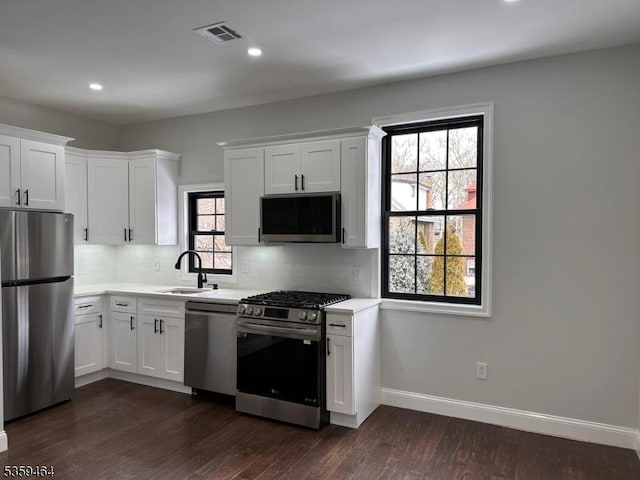 228 78th St, North Bergen Twp, NJ 07047 - kitchen featuring stainless steel appliances, a sink, light countertops, tasteful backsplash, and white cabinets