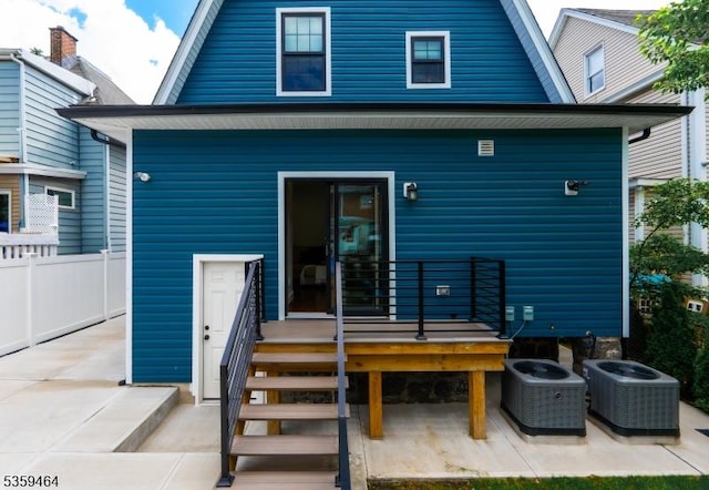 228 78th St, North Bergen Twp, NJ 07047 - back of house with a gambrel roof, central AC unit, and a patio