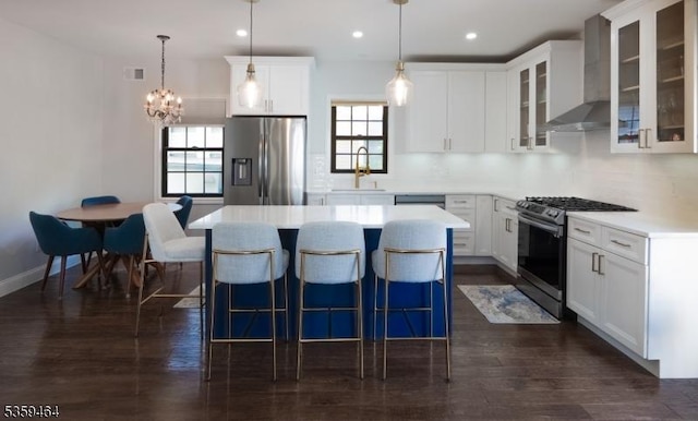 228 78th St, North Bergen Twp, NJ 07047 - kitchen with appliances with stainless steel finishes, a sink, wall chimney exhaust hood, a kitchen island, and plenty of natural light