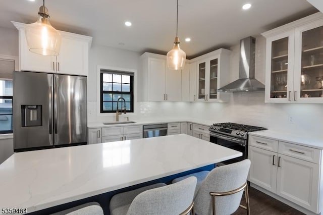 228 78th St, North Bergen Twp, NJ 07047 - kitchen with wall chimney range hood, appliances with stainless steel finishes, a sink, decorative backsplash, and recessed lighting