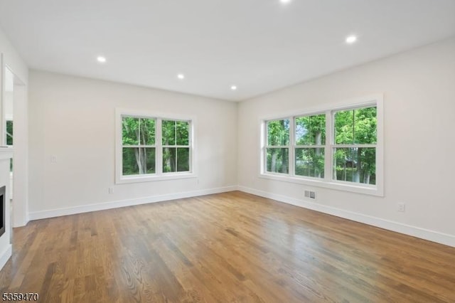 1 Willow Pl, East Hanover Twp, NJ 07936 - unfurnished living room featuring healthy amount of natural light, baseboards, wood finished floors, and recessed lighting
