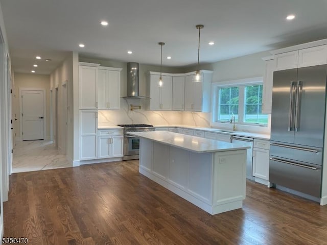 1 Willow Pl, East Hanover Twp, NJ 07936 - kitchen with wall chimney range hood, premium appliances, light countertops, white cabinets, and a sink