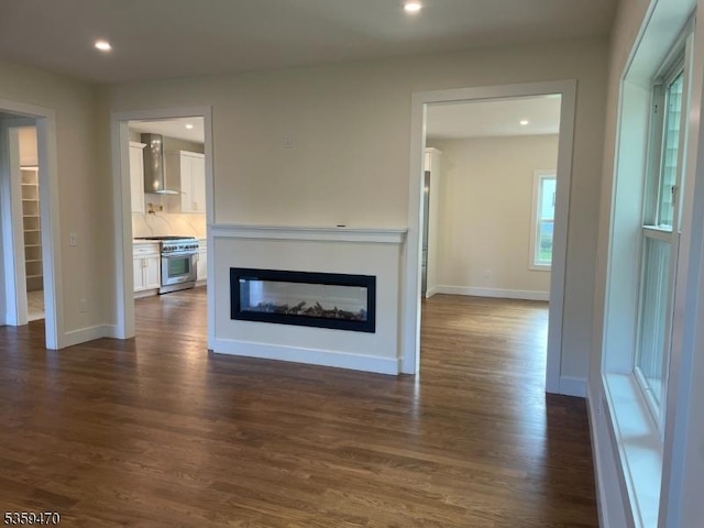 1 Willow Pl, East Hanover Twp, NJ 07936 - unfurnished living room featuring dark wood-type flooring, recessed lighting, a glass covered fireplace, and baseboards