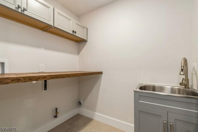32 N Ave, Fanwood Boro, NJ 07023 - laundry area with baseboards, gas dryer hookup, washer hookup, light tile patterned floors, and cabinet space