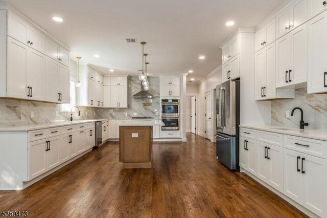 32 N Ave, Fanwood Boro, NJ 07023 - kitchen with appliances with stainless steel finishes, a sink, wall chimney range hood, backsplash, and a kitchen island