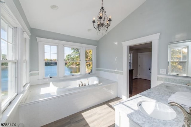 1 Brook Valley Ter, Kinnelon Boro, NJ 07405 - full bathroom with a bath, double vanity, wood finished floors, a chandelier, and high vaulted ceiling
