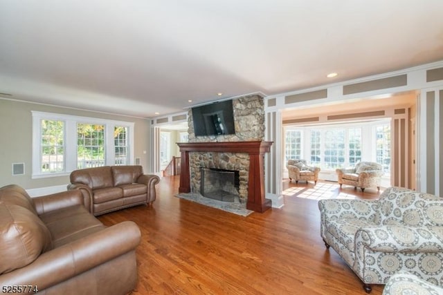 1 Brook Valley Ter, Kinnelon Boro, NJ 07405 - living area featuring ornamental molding, wood finished floors, plenty of natural light, a stone fireplace, and recessed lighting
