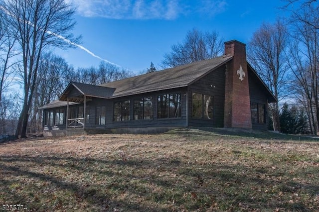 1 Brook Valley Ter, Kinnelon Boro, NJ 07405 - view of property exterior with a chimney and a sunroom