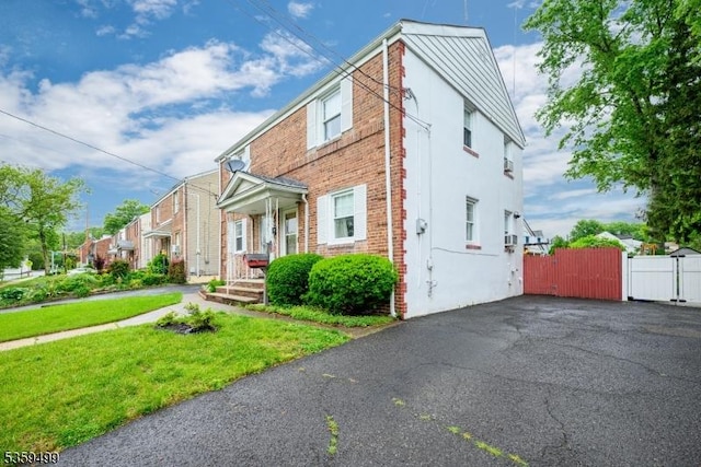 777 W Scott Ave, Rahway City, NJ 07065 - view of front facade featuring a gate, brick siding, and asphalt driveway