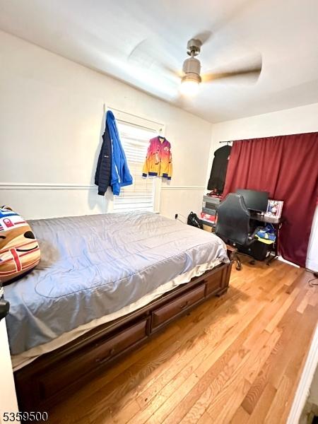 341 S 18th St, Newark City, NJ 07103 - bedroom with wood finished floors and a ceiling fan
