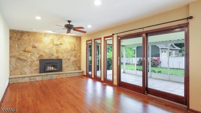 700 Schoolhouse Ln, Bound Brook Boro, NJ 08805 - unfurnished living room with wood finished floors, ceiling fan, a fireplace, and recessed lighting