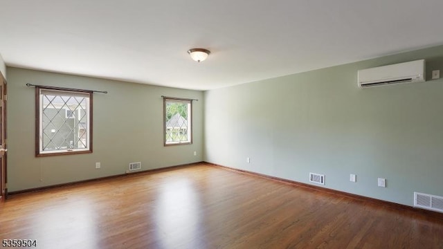 700 Schoolhouse Ln, Bound Brook Boro, NJ 08805 - unfurnished room featuring a wall mounted air conditioner, wood finished floors, and baseboards