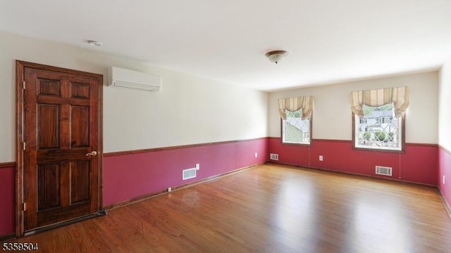 700 Schoolhouse Ln, Bound Brook Boro, NJ 08805 - spare room featuring a wall unit AC and wood finished floors