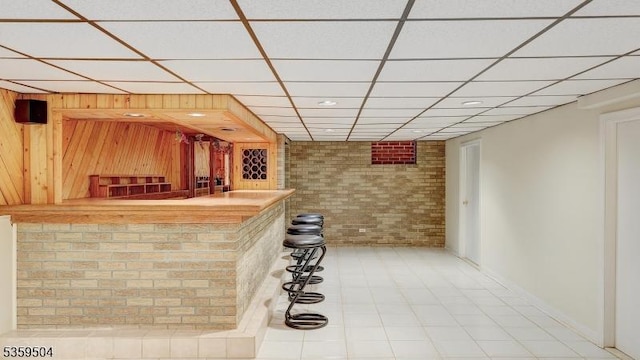 700 Schoolhouse Ln, Bound Brook Boro, NJ 08805 - indoor dry bar featuring brick wall, a paneled ceiling, tile patterned floors, wood walls, and recessed lighting