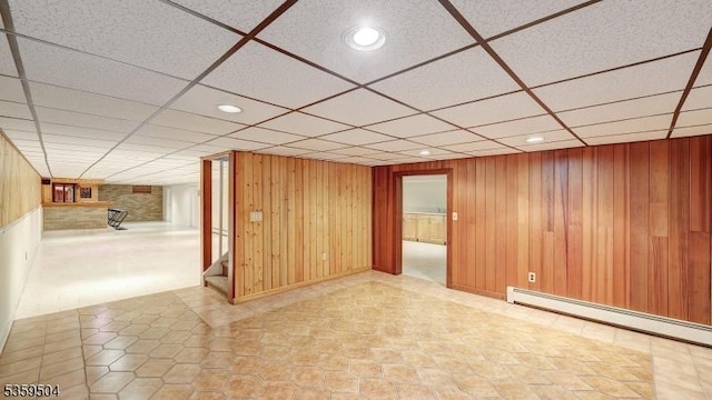 700 Schoolhouse Ln, Bound Brook Boro, NJ 08805 - empty room with a baseboard radiator, stairs, a paneled ceiling, recessed lighting, and wooden walls