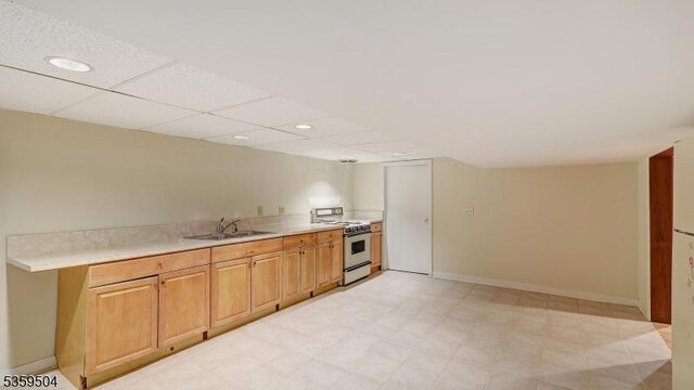 700 Schoolhouse Ln, Bound Brook Boro, NJ 08805 - kitchen with range with gas cooktop, a sink, light countertops, recessed lighting, and baseboards