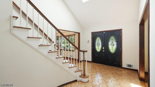 700 Schoolhouse Ln, Bound Brook Boro, NJ 08805 - tiled entrance foyer with high vaulted ceiling, stairs, and baseboards