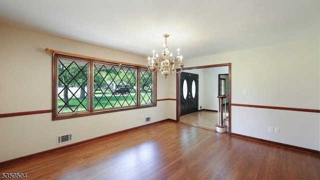 700 Schoolhouse Ln, Bound Brook Boro, NJ 08805 - empty room with a chandelier, wood finished floors, and baseboards