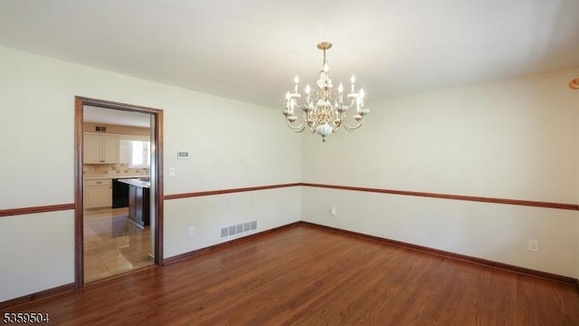 700 Schoolhouse Ln, Bound Brook Boro, NJ 08805 - unfurnished room with a chandelier, wood finished floors, and baseboards