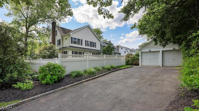 265 S Scotch Plains Ave, Westfield Town, NJ 07090 - view of side of home with a chimney and a garage
