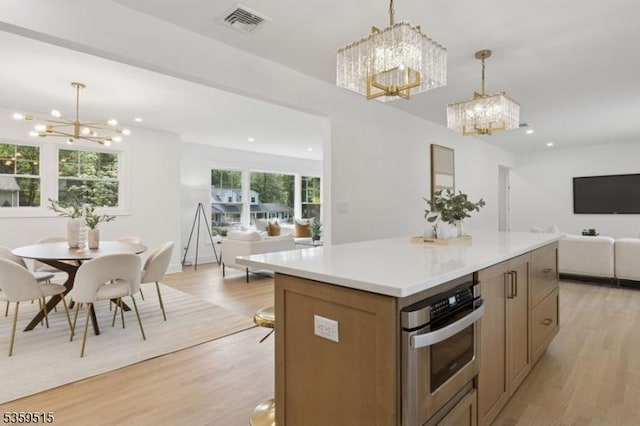 17 Misty Mountain Rd, Randolph Twp, NJ 07869 - kitchen featuring a chandelier, open floor plan, oven, light wood-type flooring, and a kitchen island