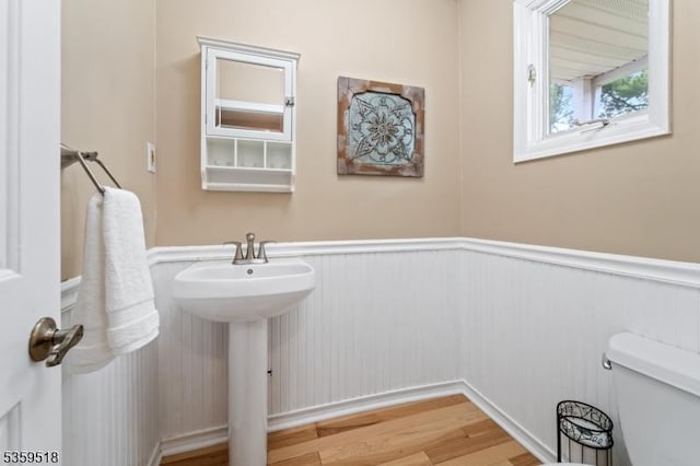 2406 Jamestown Cmn, Hillsborough Twp, NJ 08844 - bathroom with a wainscoted wall, wood finished floors, toilet, and a sink