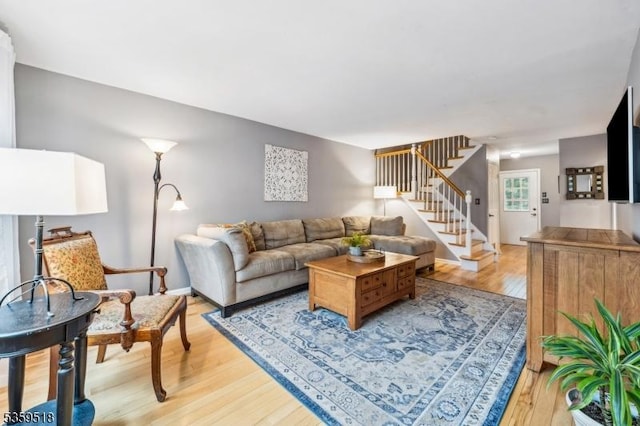 2406 Jamestown Cmn, Hillsborough Twp, NJ 08844 - living room featuring stairs and light wood-type flooring