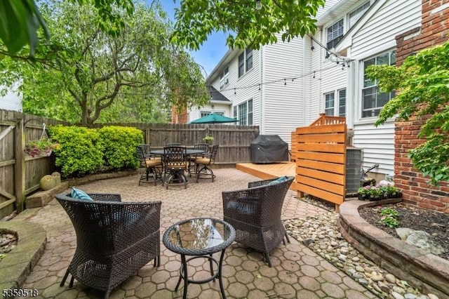 2406 Jamestown Cmn, Hillsborough Twp, NJ 08844 - fenced backyard featuring a grill, outdoor dining space, and a patio area