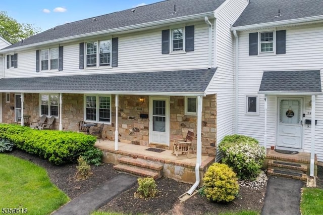 2406 Jamestown Cmn, Hillsborough Twp, NJ 08844 - view of front of property featuring a porch, a shingled roof, and stone siding
