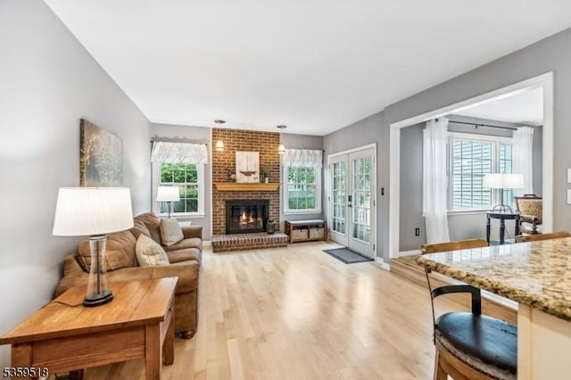 2406 Jamestown Cmn, Hillsborough Twp, NJ 08844 - living room featuring light wood finished floors, a fireplace, and baseboards