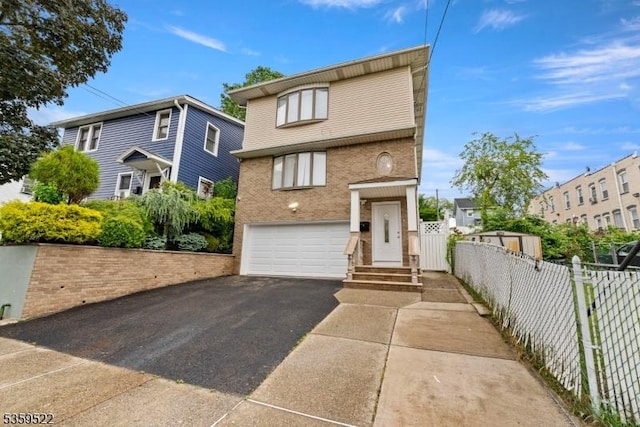 409 Washington St, Carlstadt Boro, NJ 07072 - view of front of property with asphalt driveway, a garage, and brick siding