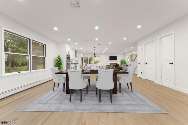 409 Washington St, Carlstadt Boro, NJ 07072 - dining space featuring light wood-style floors, recessed lighting, and a baseboard heating unit