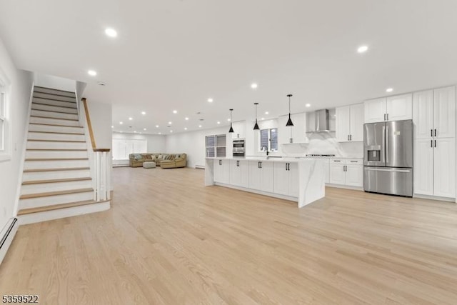 409 Washington St, Carlstadt Boro, NJ 07072 - unfurnished living room with recessed lighting, light wood-type flooring, stairs, and a sink