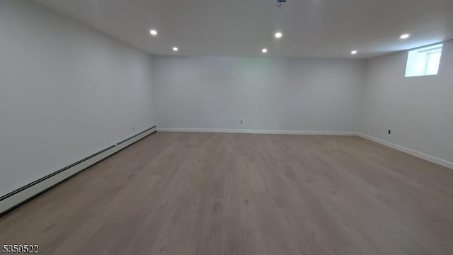 409 Washington St, Carlstadt Boro, NJ 07072 - empty room featuring a baseboard radiator, light wood-style flooring, recessed lighting, and baseboards