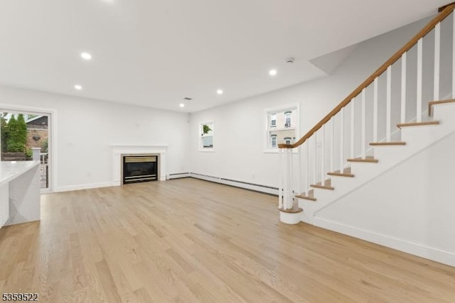 409 Washington St, Carlstadt Boro, NJ 07072 - unfurnished living room with a baseboard radiator, light wood finished floors, healthy amount of natural light, recessed lighting, and a glass covered fireplace