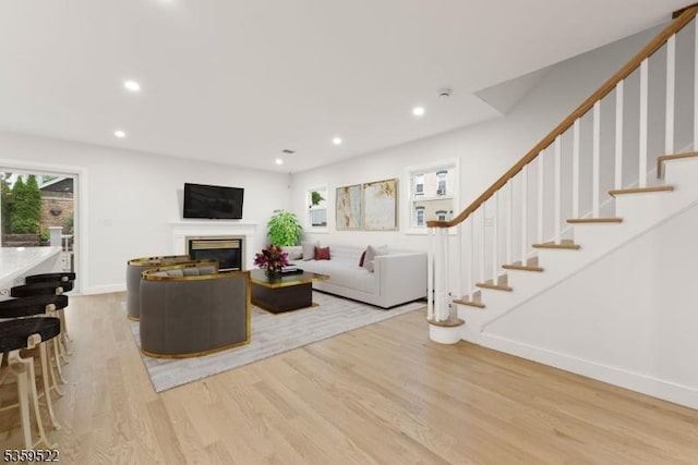 409 Washington St, Carlstadt Boro, NJ 07072 - living room featuring light wood-type flooring, plenty of natural light, a glass covered fireplace, and recessed lighting