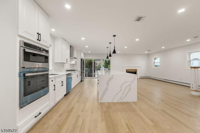 409 Washington St, Carlstadt Boro, NJ 07072 - kitchen with appliances with stainless steel finishes, white cabinetry, plenty of natural light, a kitchen island, and recessed lighting