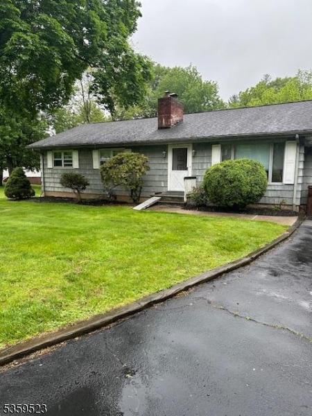 667 Foothill Rd, Bridgewater Twp, NJ 08807 - view of front of home with a chimney, a front yard, and entry steps