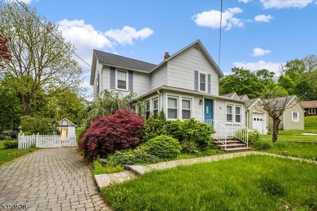 19 Spring St, Ogdensburg Boro, NJ 07439 - traditional home with a chimney, driveway, and an attached garage